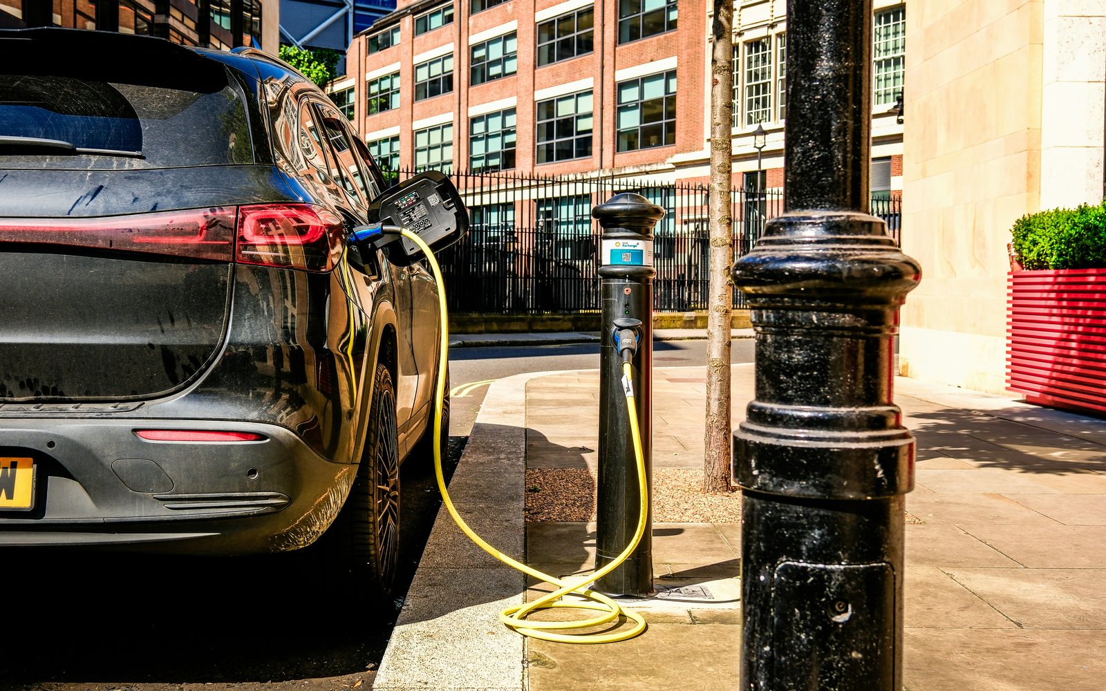 Electric vehicle charging at a station on a city street